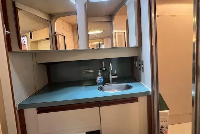 Slide: The Image of Interior of 1989 Trojan 12 Meter Motor Yacht bathroom with sink and mirror. - 37
