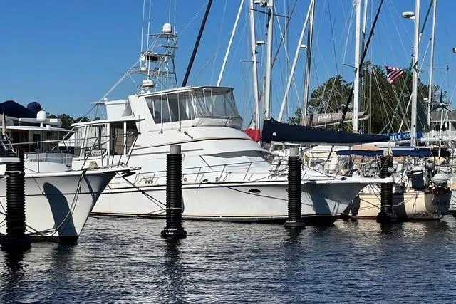Slide: The Image of 1989 Trojan 12 Meter Motor Yacht docked at marina with sailboats. - 4
