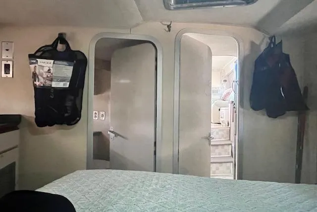 Slide: The Image of Interior of 1989 Trojan 12 Meter Motor Yacht cabin with bed and open doors. - 40