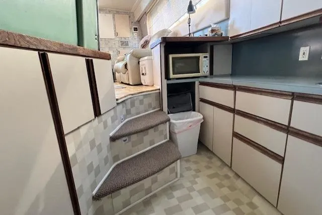 Slide: The Image of Interior of 1989 Trojan 12 Meter Motor Yacht with kitchenette and stairs. - 41