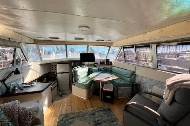 Slide: The Image of 1989 Trojan 12 Meter Motor Yacht interior with spacious seating and panoramic windows. - 42