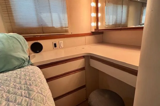 Slide: The Image of 1989 Trojan 12 Meter Motor Yacht interior with vanity, mirror, and cozy bedding. - 44
