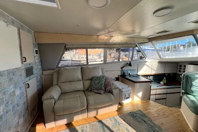 Slide: The Image of Interior of a 1989 Trojan 12 Meter Motor Yacht with cozy seating and panoramic windows. - 45