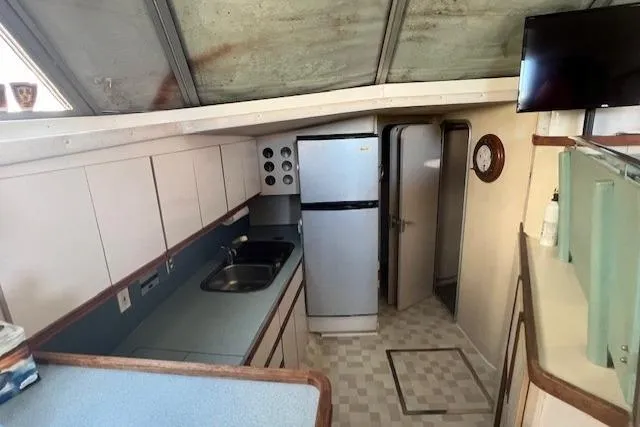 Slide: The Image of Interior of 1989 Trojan 12 Meter Motor Yacht kitchen with appliances and cabinetry. - 46
