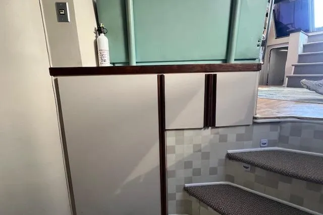 Slide: The Image of Interior of 1989 Trojan 12 Meter Motor Yacht with stairs and storage cabinets. - 51
