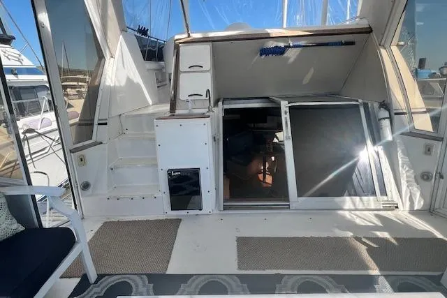 Slide: The Image of 1989 Trojan 12 Meter Motor Yacht interior with open cabin door and seating area. - 9