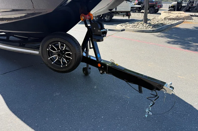 Slide: The Image of Trailer hitch of a 2026 MasterCraft NXT24 boat on pavement. - 10