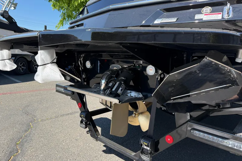 Slide: The Image of Rear view of 2026 MasterCraft NXT24 boat showing propeller and trim tabs. - 13