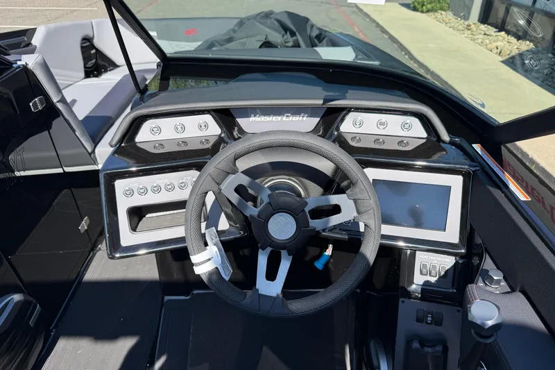 Slide: The Image of 2026 MasterCraft NXT24 boat dashboard with steering wheel and control panel. - 14