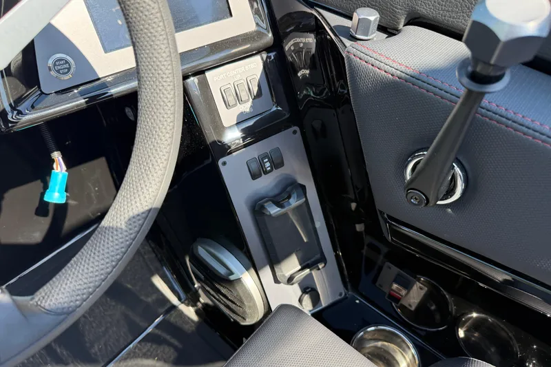 Slide: The Image of 2026 MasterCraft NXT24 boat dashboard with steering wheel and control panel. - 15