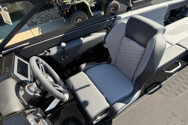 Slide: The Image of 2026 MasterCraft NXT24 boat interior with modern steering and comfortable seating. - 16