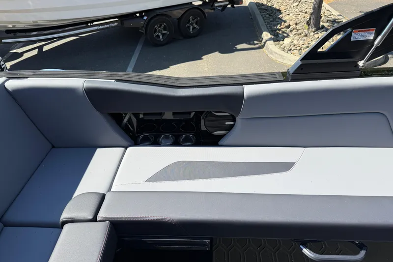 Slide: The Image of Interior seating of 2026 MasterCraft NXT24 boat, featuring cup holders and sleek design. - 21