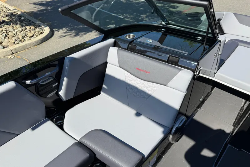 Slide: The Image of 2026 MasterCraft NXT24 boat interior with gray seating and modern design. - 23