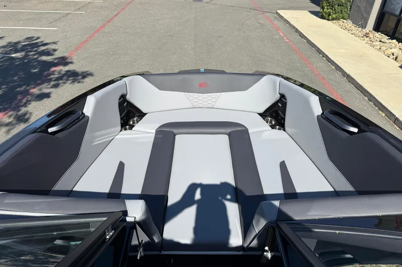 Slide: The Image of 2026 MasterCraft NXT24 boat interior with gray seating and modern design. - 24