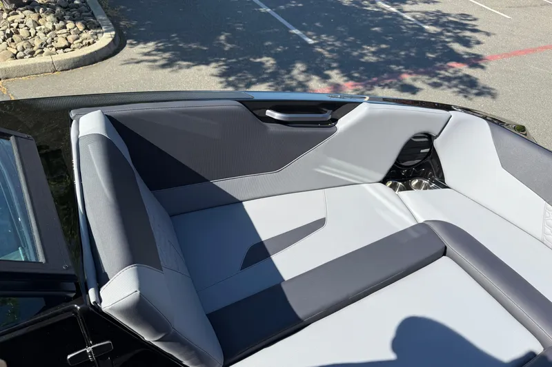 Slide: The Image of 2026 MasterCraft NXT24 boat interior with sleek gray seating and modern design. - 25