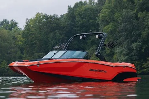 Slide: The Image of 2026 MasterCraft NXT24 boat on trailer outside dealership. - 4