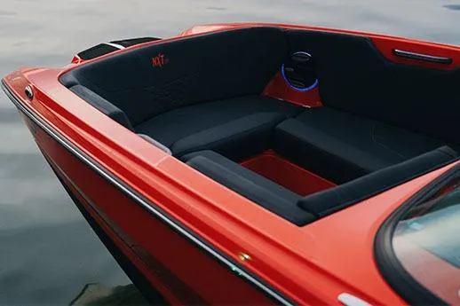 Slide: The Image of 2026 MasterCraft NXT24 boat rear view in a parking lot, sunny day. - 5