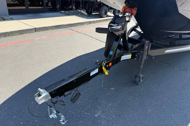 Slide: The Image of Trailer hitch of a 2026 MasterCraft NXT24 boat on pavement. - 9