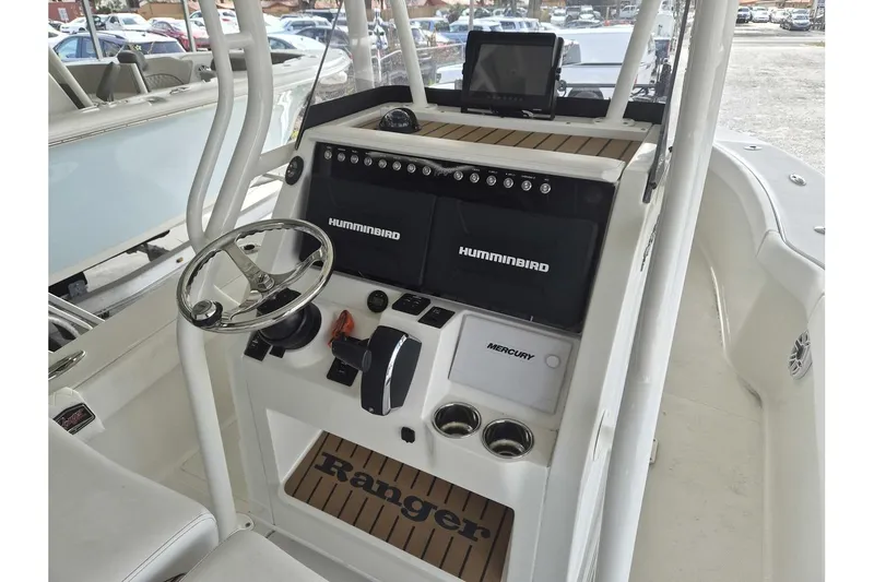 Slide: The Image of 2026 Ranger 2600 Bay boat console with steering wheel, Humminbird electronics, and Mercury controls. - 10