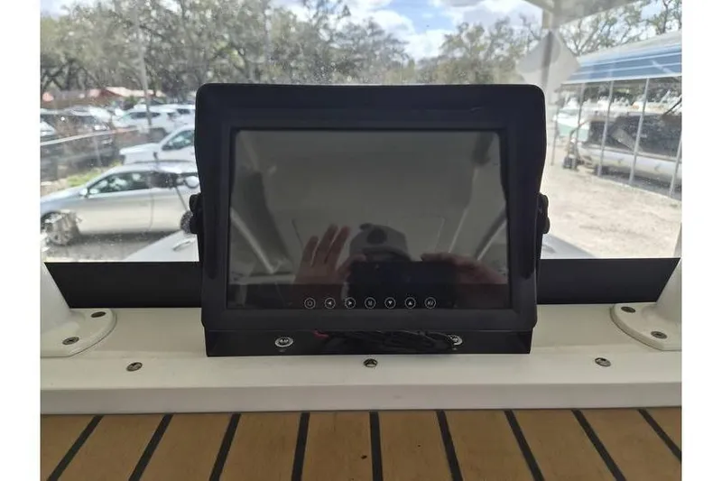 Slide: The Image of 2026 Ranger 2600 Bay boat dashboard with touchscreen display, outdoor setting. - 11