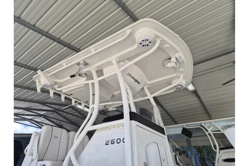 Slide: The Image of 2026 Ranger 2600 Bay boat under a metal canopy, showcasing its sleek design and features. - 14