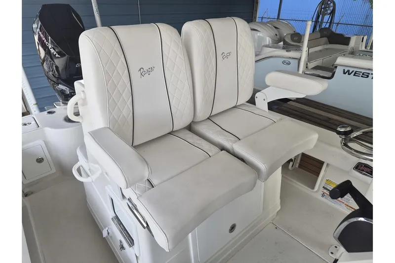 Slide: The Image of Luxury seating on 2026 Ranger 2600 Bay boat with white upholstery and armrests. - 15