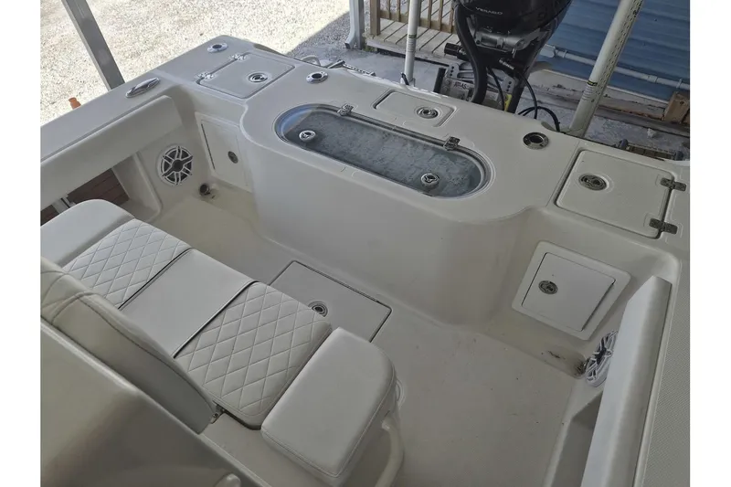 Slide: The Image of 2026 Ranger 2600 Bay boat interior with seating, storage, and livewell. - 18