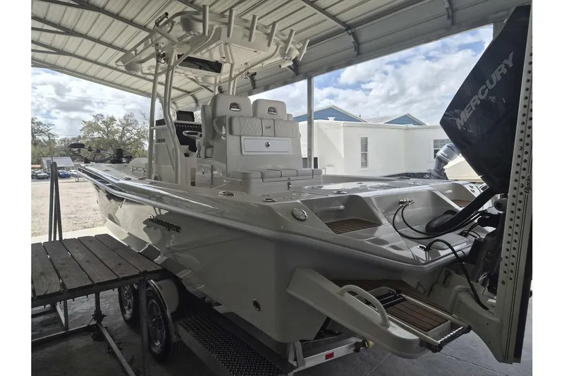 Slide: The Image of 2026 Ranger 2600 Bay boat under a metal canopy, featuring a Mercury engine. - 4