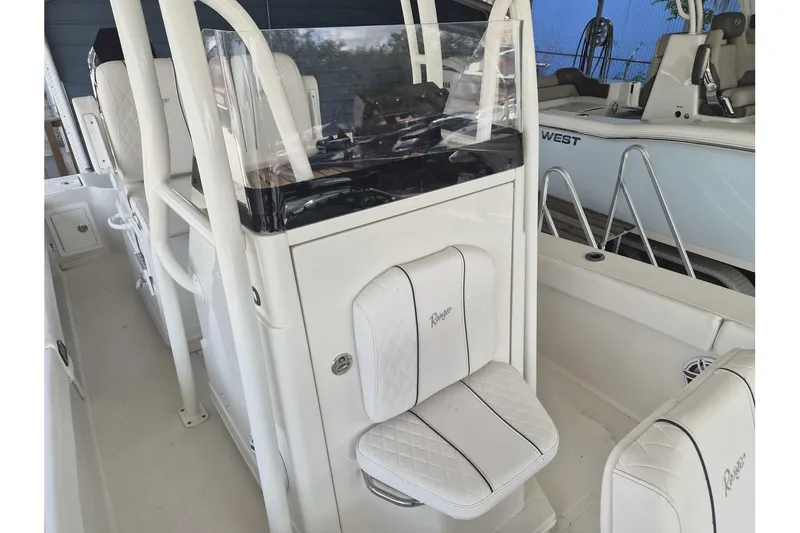 Slide: The Image of 2026 Ranger 2600 Bay boat interior with white seating and console. - 6