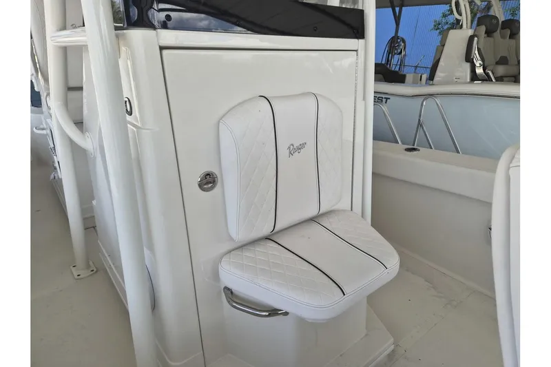 Slide: The Image of 2026 Ranger 2600 Bay boat with white cushioned seat and sleek design. - 7
