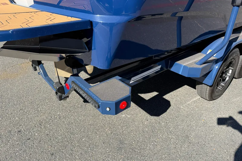 Slide: The Image of Rear view of a 2026 MasterCraft NXT23 boat on a trailer. - 11
