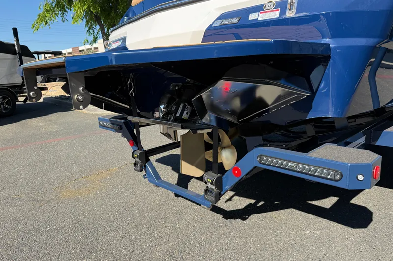 Slide: The Image of Rear view of 2026 MasterCraft NXT23 boat, showcasing propeller and hull design. - 12