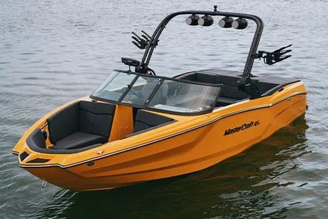 Slide: The Image of Manufacturer Provided Image: 2026 MasterCraft NXT23 boat in vibrant orange on calm water. - 28