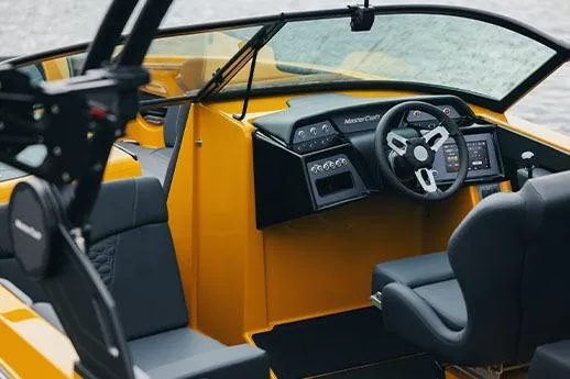 Slide: The Image of Manufacturer Provided Image: 2026 MasterCraft NXT23 boat interior with modern dashboard and steering wheel. - 3