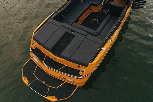 Slide: The Image of Manufacturer Provided Image: 2026 MasterCraft NXT23 boat with sleek black and orange design on water. - 5