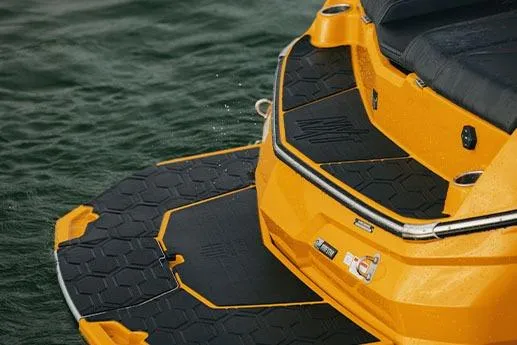 Slide: The Image of Manufacturer Provided Image: 2026 MasterCraft NXT23 boat with vibrant yellow and black deck on water. - 6