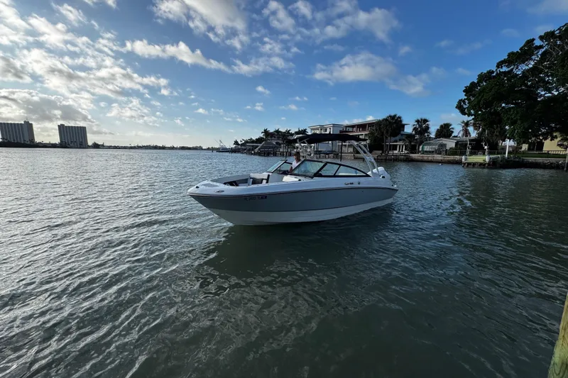 Slide: The Image of 2023 Monterey M-225 boat on calm water under a partly cloudy sky. - 13