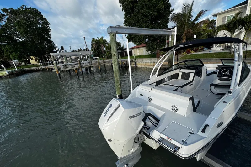 Slide: The Image of 2023 Monterey M-225 boat docked by waterfront, featuring Mercury outboard motor. - 17