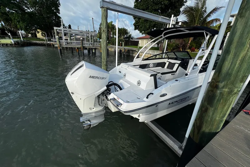 Slide: The Image of 2023 Monterey M-225 boat with Mercury outboard engine docked by waterfront. - 18