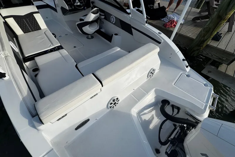 Slide: The Image of 2023 Monterey M-225 boat interior with white seating and modern design. - 19