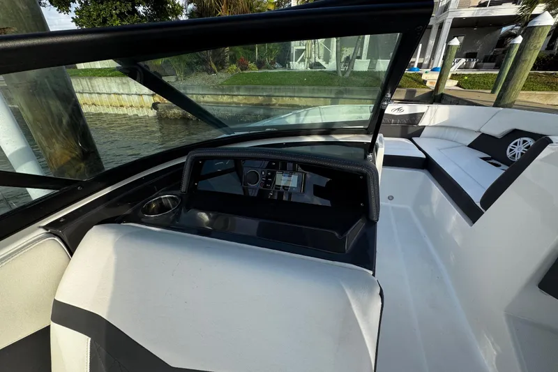 Slide: The Image of 2023 Monterey M-225 boat interior with sleek dashboard and spacious seating. - 21