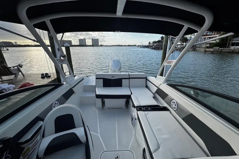 Slide: The Image of 2023 Monterey M-225 boat interior with waterfront view, featuring seating and modern design. - 28
