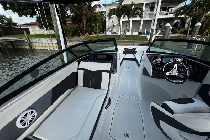 Slide: The Image of 2023 Monterey M-225 boat interior with sleek seating and modern dashboard design. - 29