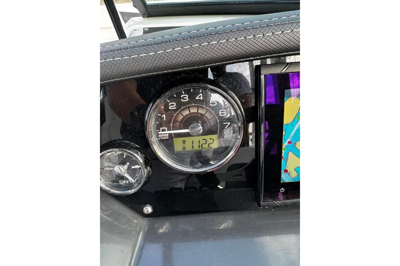 Slide: The Image of Dashboard of 2023 Monterey M-225 boat showing RPM gauge and navigation screen. - 31