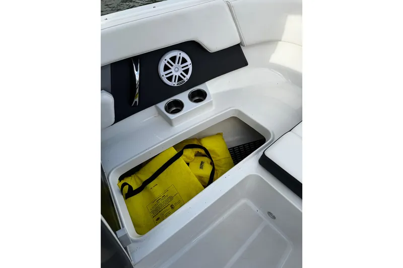 Slide: The Image of 2023 Monterey M-225 boat interior with storage compartment and yellow life jackets. - 32
