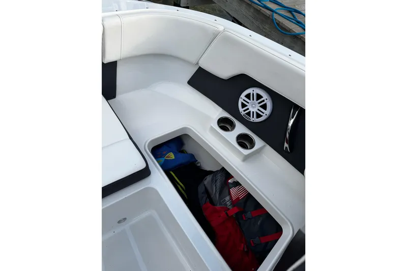Slide: The Image of 2023 Monterey M-225 boat interior with storage compartment and speaker. - 34