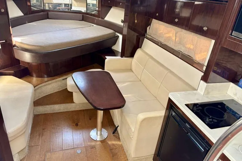 Slide: The Image of Luxurious interior of 2018 Sea Ray Sundancer 350 Coupe with seating, table, and kitchenette. - 10