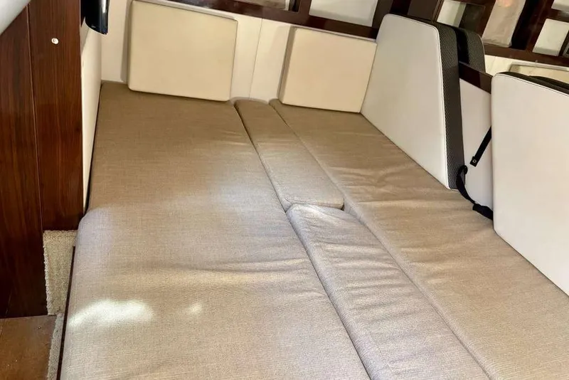 Slide: The Image of Interior cabin of 2018 Sea Ray Sundancer 350 Coupe with beige seating. - 14