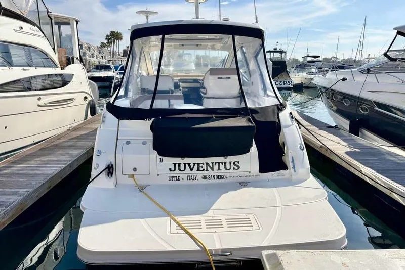 Slide: The Image of 2018 Sea Ray Sundancer 350 Coupe docked at marina, rear view. - 2