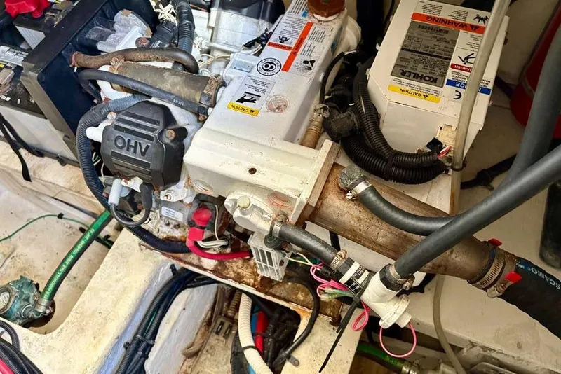 Slide: The Image of Engine compartment of a 2018 Sea Ray Sundancer 350 Coupe with visible wiring and components. - 24